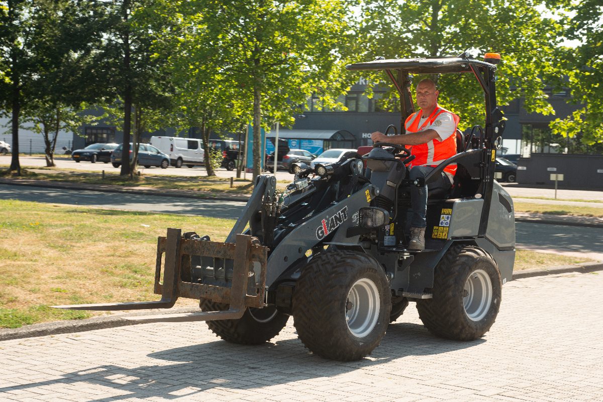 Vakman aan het werk met een shovel in de openbare ruimte
